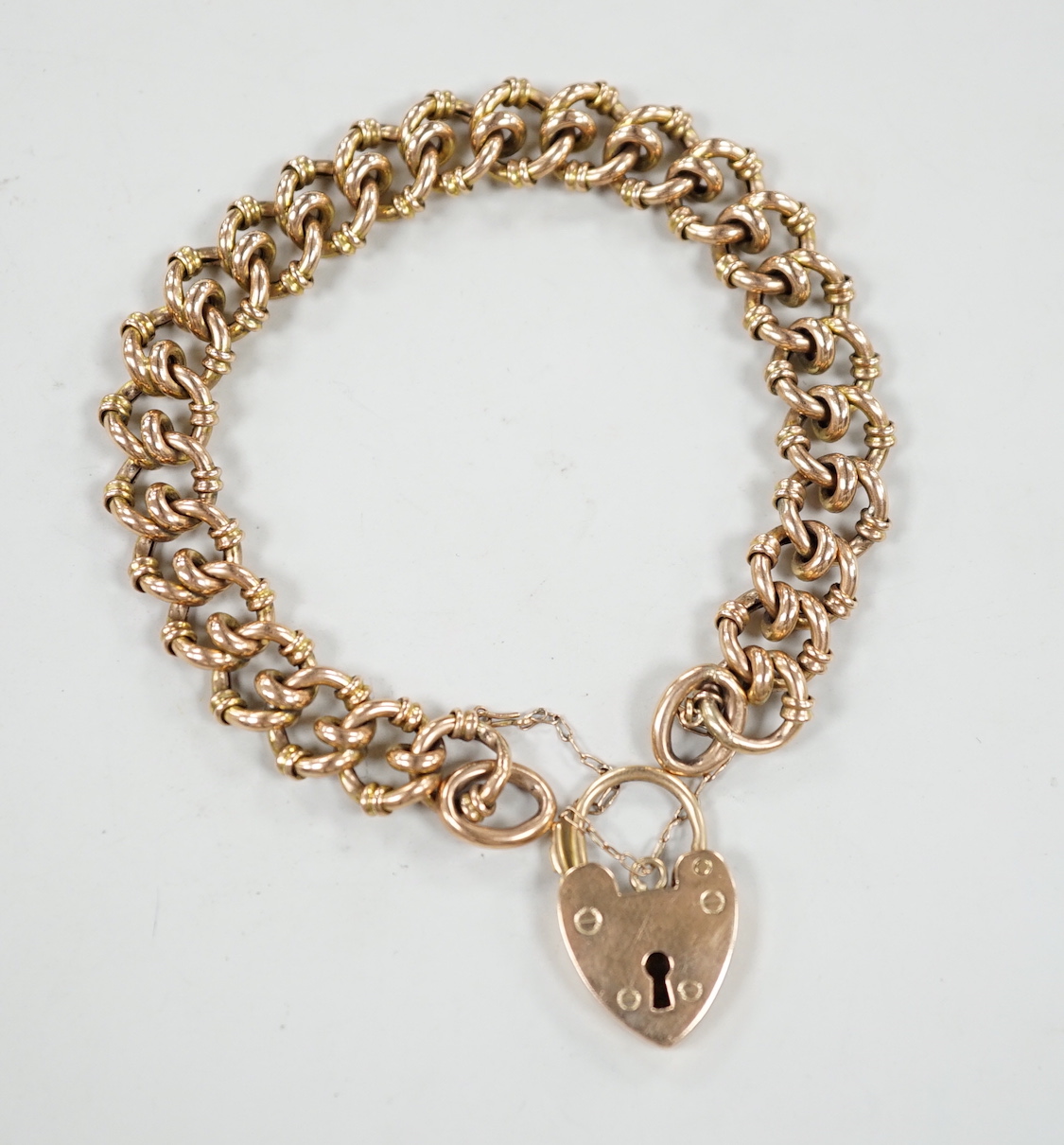 A 9ct fancy circular link bracelet with padlock clasp, 16cm